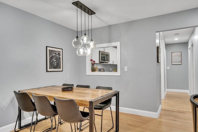 32 Juniper St Unit 91, Brookline, MA 02445 - dining space featuring light wood finished floors and baseboards