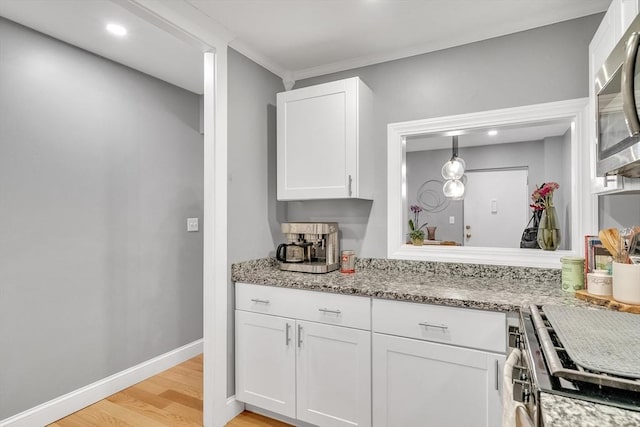 32 Juniper St Unit 91, Brookline, MA 02445 - kitchen with stainless steel appliances, white cabinets, light wood finished floors, light stone countertops, and recessed lighting