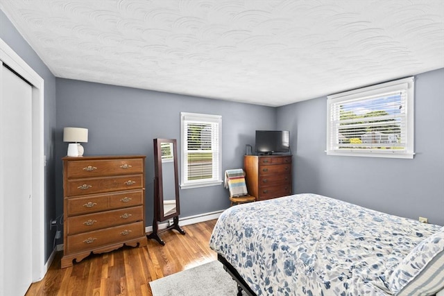 58 Spring St, Weymouth, MA 02188 - bedroom with wood finished floors, baseboards, a closet, and a textured ceiling