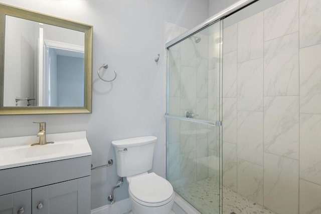 bathroom with vanity, toilet, and walk in shower