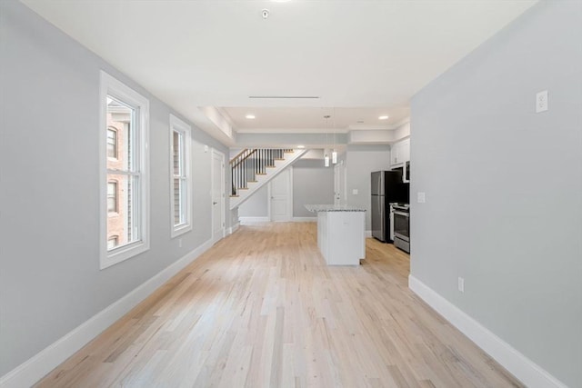 unfurnished living room featuring light hardwood / wood-style floors