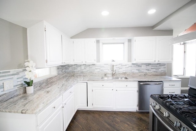 kitchen with a sink, stainless steel gas range, white cabinetry, dark wood finished floors, and dishwashing machine