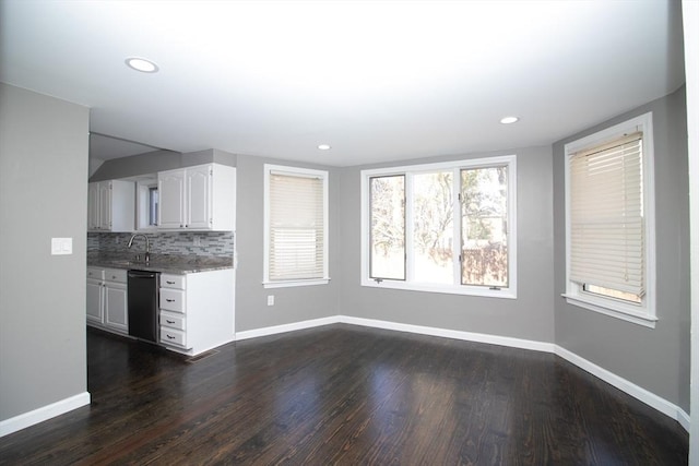 kitchen with dishwasher, baseboards, dark wood-style flooring, a sink, and recessed lighting