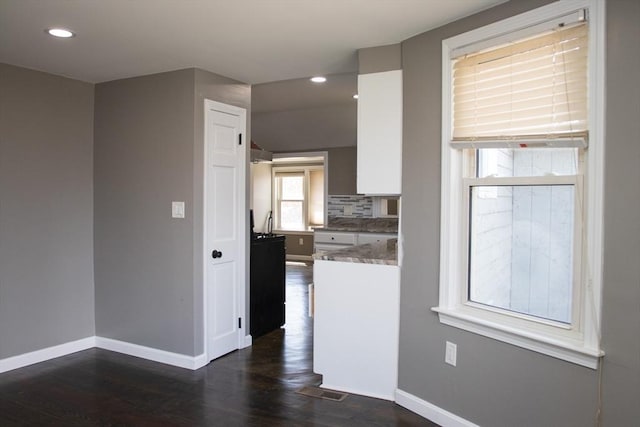 kitchen featuring baseboards, dark wood-type flooring, recessed lighting, white cabinets, and tasteful backsplash