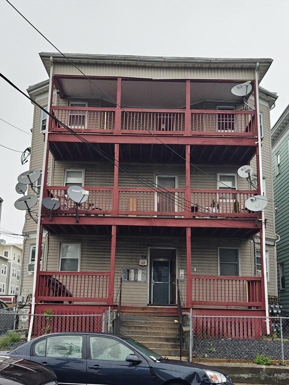 54 Shirley Ave, Revere, MA 02151 - view of front of home featuring a balcony, a porch, and fence