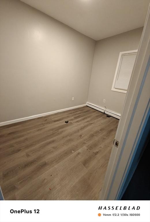 54 Shirley Ave, Revere, MA 02151 - empty room featuring a baseboard radiator, baseboards, and dark wood-style floors