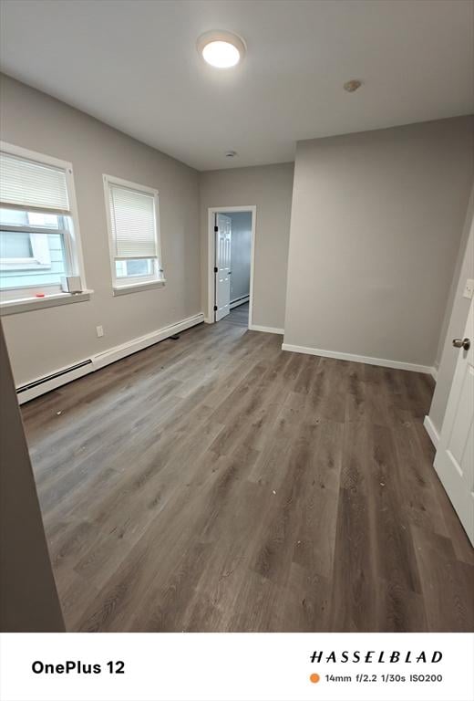 54 Shirley Ave, Revere, MA 02151 - unfurnished room with baseboard heating, wood finished floors, and baseboards
