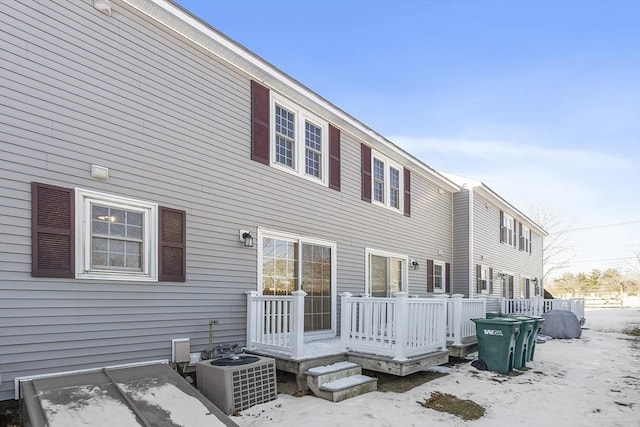 snow covered property featuring a wooden deck