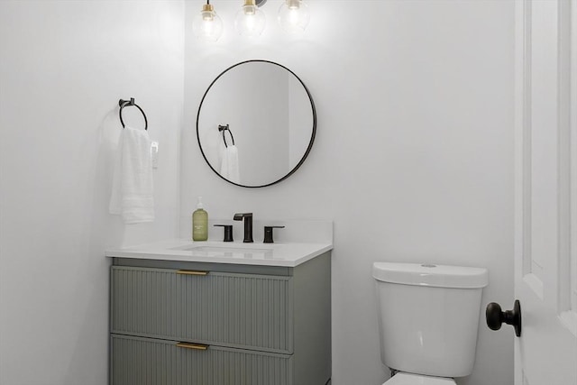 bathroom with toilet and vanity