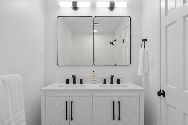 bathroom featuring walk in shower and vanity