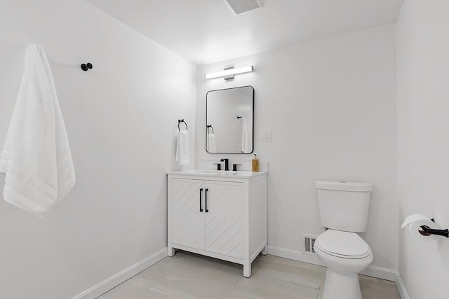 bathroom featuring tile patterned floors, toilet, and vanity