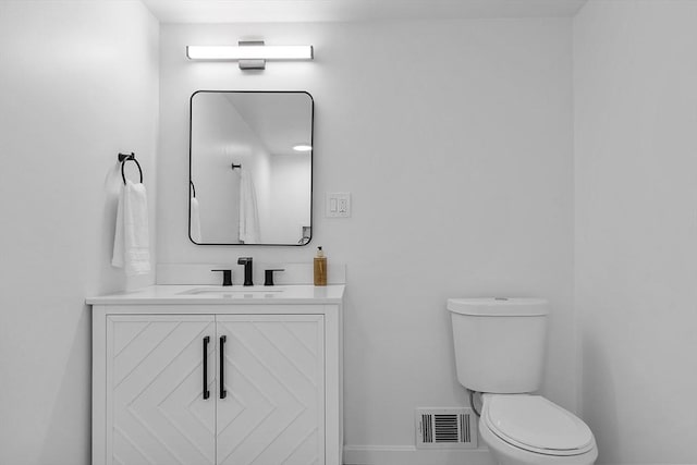 bathroom featuring toilet and vanity