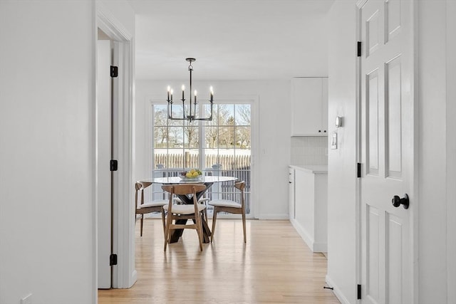 dining space featuring a notable chandelier and light hardwood / wood-style flooring