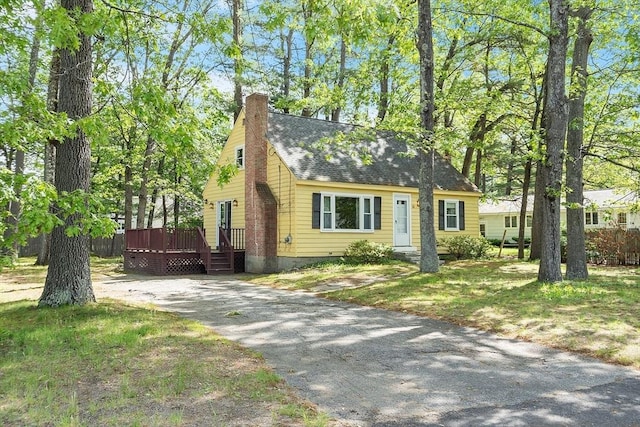 15 Moore Rd, Westford, MA 01886 - cape cod house with a wooden deck, a chimney, and a shingled roof