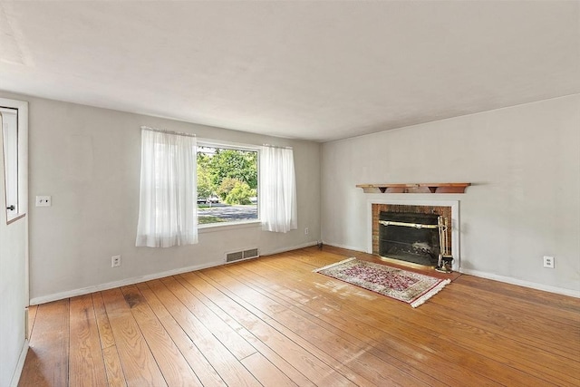 15 Moore Rd, Westford, MA 01886 - unfurnished living room featuring hardwood / wood-style flooring, a fireplace, and baseboards