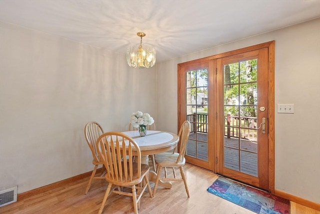 15 Moore Rd, Westford, MA 01886 - dining room with a chandelier, light wood finished floors, and baseboards