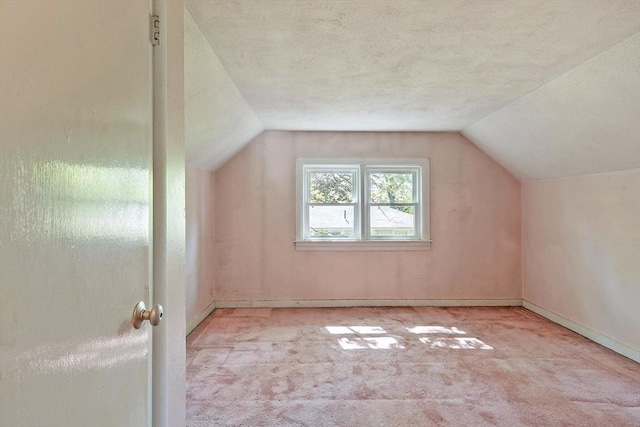 15 Moore Rd, Westford, MA 01886 - bonus room with carpet floors, vaulted ceiling, baseboards, and a textured ceiling