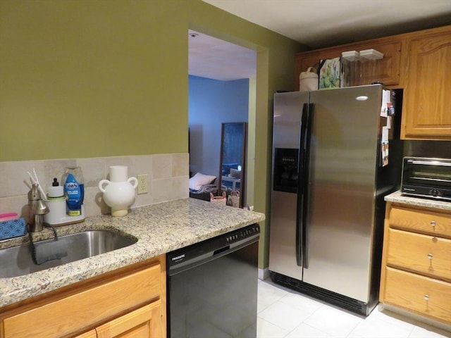 155 Kendrick Ave Unit 306, Quincy, MA 02169 - kitchen featuring stainless steel fridge, black dishwasher, light tile patterned flooring, and light stone countertops