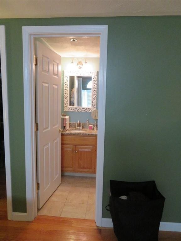 155 Kendrick Ave Unit 306, Quincy, MA 02169 - bathroom with vanity, wood finished floors, and baseboards