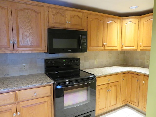 155 Kendrick Ave Unit 306, Quincy, MA 02169 - kitchen with black appliances, light stone countertops, and tasteful backsplash