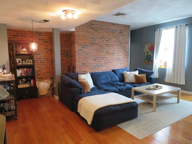 155 Kendrick Ave Unit 306, Quincy, MA 02169 - living area featuring wood finished floors and brick wall