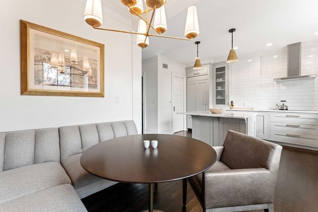 dining space with crown molding and dark hardwood / wood-style flooring