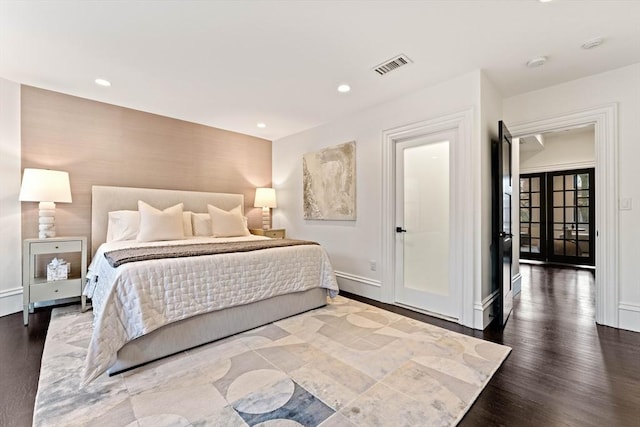 bedroom featuring hardwood / wood-style flooring and french doors