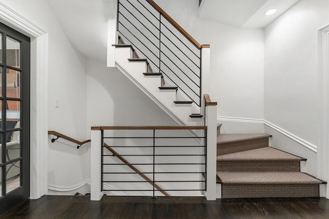 stairway with hardwood / wood-style flooring