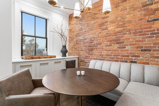 dining area with brick wall and beverage cooler