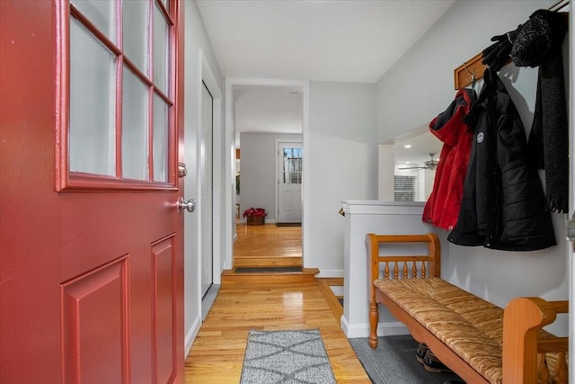 mudroom featuring light wood-style flooring and baseboards