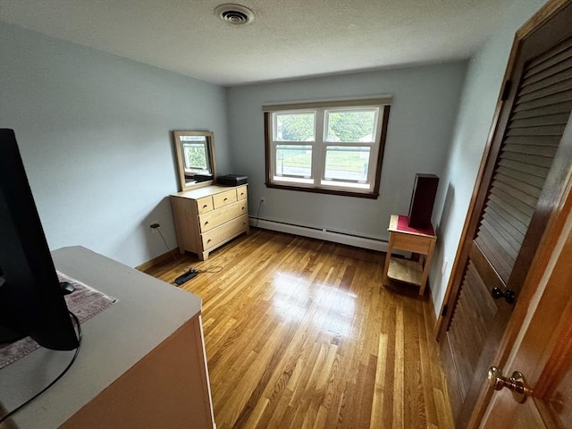 43 Shirley Ave, Methuen, MA 01844 - bedroom with baseboard heating and light wood-style floors