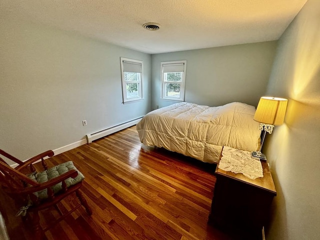 43 Shirley Ave, Methuen, MA 01844 - bedroom with a baseboard heating unit, wood finished floors, and a textured ceiling