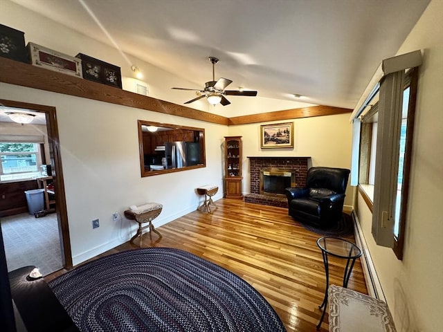 43 Shirley Ave, Methuen, MA 01844 - living area with lofted ceiling, ceiling fan, a fireplace, and wood finished floors