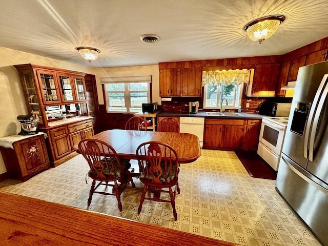 43 Shirley Ave, Methuen, MA 01844 - kitchen with white appliances, plenty of natural light, under cabinet range hood, and glass insert cabinets
