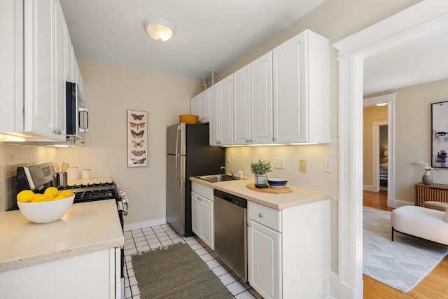 854 Massachusetts Ave Unit 11, Cambridge, MA 02139 - kitchen featuring stainless steel appliances, backsplash, and white cabinetry