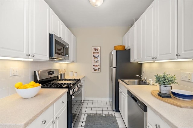 854 Massachusetts Ave Unit 11, Cambridge, MA 02139 - kitchen featuring appliances with stainless steel finishes, a sink, light tile patterned flooring, and decorative backsplash