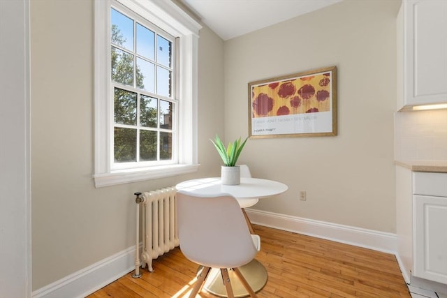 854 Massachusetts Ave Unit 11, Cambridge, MA 02139 - dining space with radiator heating unit, baseboards, and light wood-type flooring