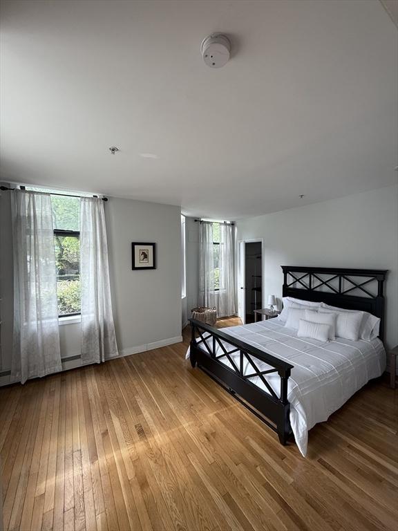 bedroom with light wood-style flooring and baseboards