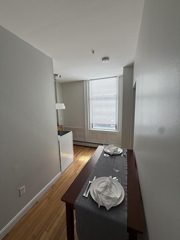 dining space with wood finished floors