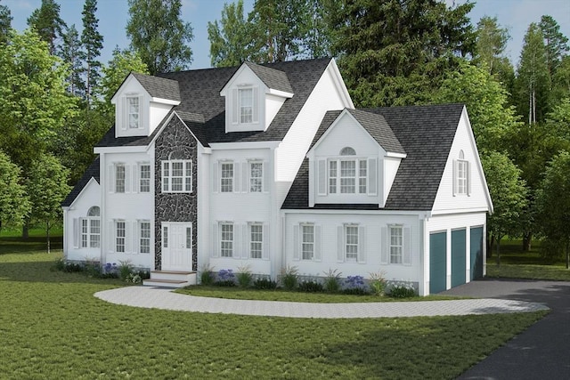colonial-style house featuring an attached garage, a front yard, and aphalt driveway