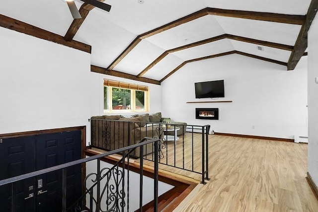 163 Walnut Rd, Wrentham, MA 02093 - staircase with vaulted ceiling, wood finished floors, baseboard heating, a glass covered fireplace, and ceiling fan