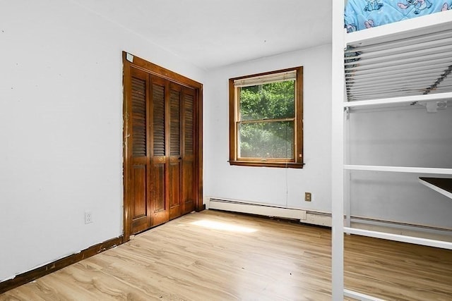 163 Walnut Rd, Wrentham, MA 02093 - unfurnished bedroom featuring wood finished floors, baseboard heating, a closet, and baseboards