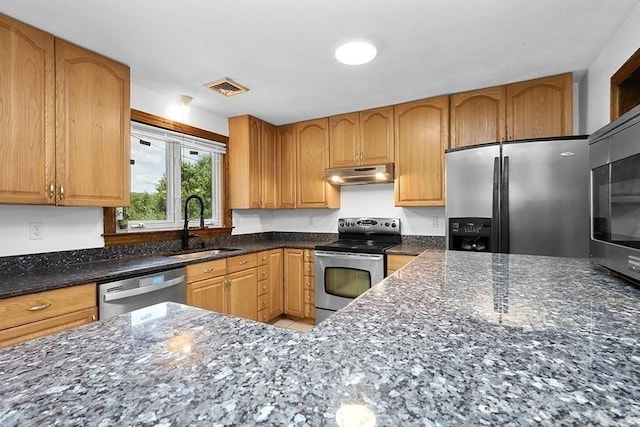 163 Walnut Rd, Wrentham, MA 02093 - kitchen featuring appliances with stainless steel finishes, under cabinet range hood, a sink, and dark stone counters