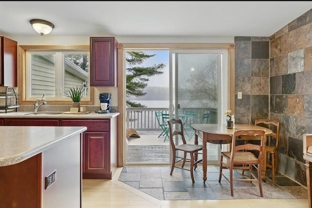 kitchen featuring a sink, dark brown cabinets, and light countertops