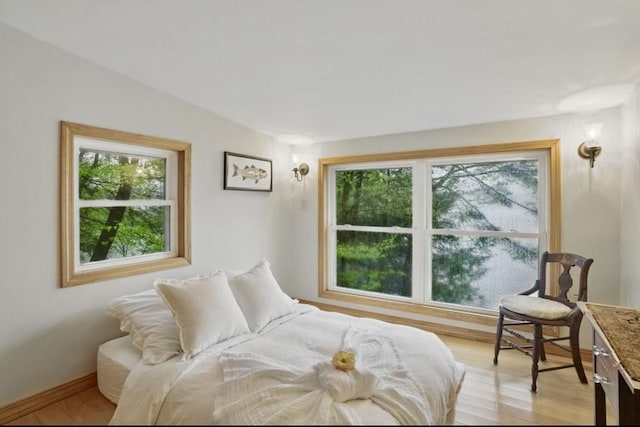 bedroom featuring light wood-type flooring and baseboards