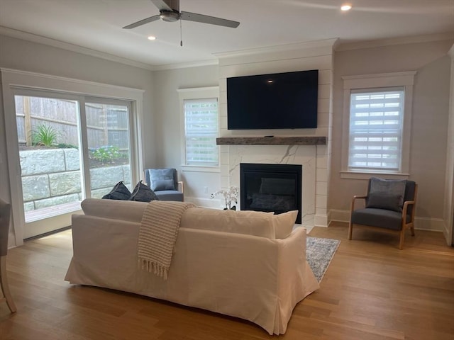255 Old Main Rd Unit 2A, Falmouth, MA 02556 - living room with crown molding, a high end fireplace, light wood finished floors, plenty of natural light, and ceiling fan