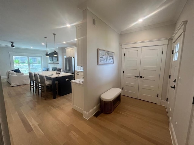 255 Old Main Rd Unit 2A, Falmouth, MA 02556 - entrance foyer with light wood-style flooring, ornamental molding, and recessed lighting