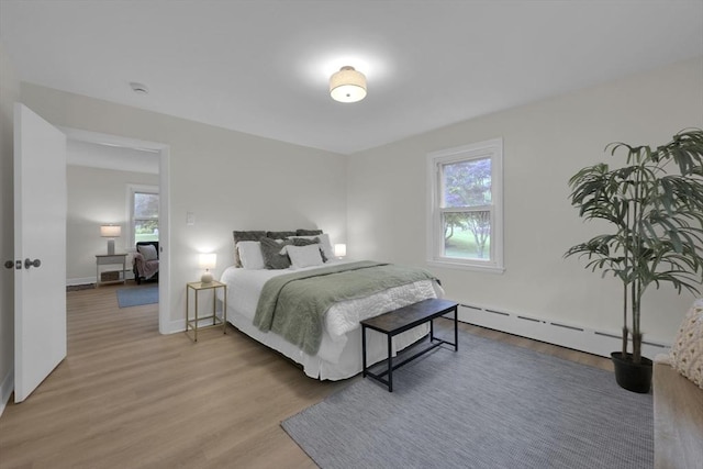 195 Pompeo Rd, Thompson, CT 06255 - bedroom featuring multiple windows, light wood-type flooring, and a baseboard heating unit