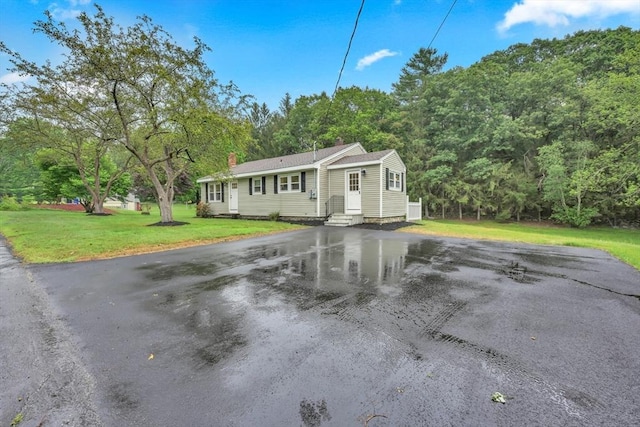 195 Pompeo Rd, Thompson, CT 06255 - ranch-style house featuring entry steps, a chimney, a front yard, and driveway