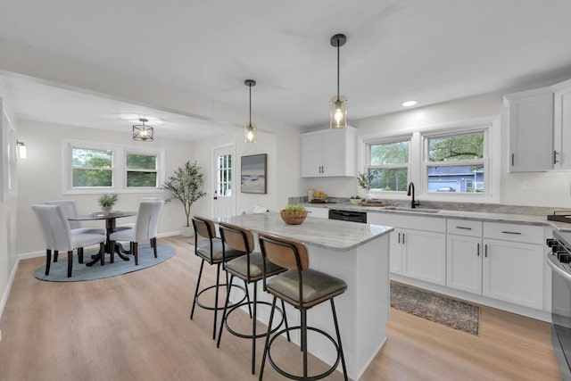 195 Pompeo Rd, Thompson, CT 06255 - kitchen with a breakfast bar area, light stone countertops, plenty of natural light, white cabinetry, and recessed lighting
